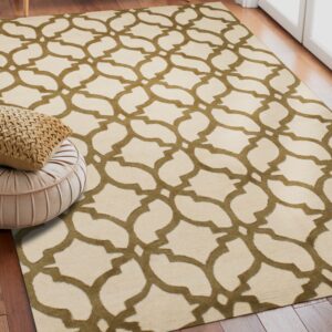 Geometric olive and cream rug on dark wood flooring, next to a pink pleated pouf and cushion.