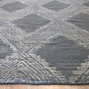 Textured gray and white rug with large diamond patterns lies on light wood planks.