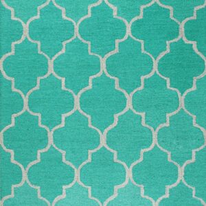 High-pile teal rug with a textured gray repeating quatrefoil geometric pattern.