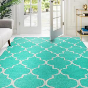 Bright aqua rug featuring a white quatrefoil pattern on a light floor near French doors.