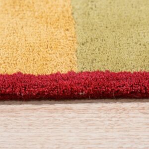 Close-up of a high-pile rug edge showing blocks of yellow, olive, and bright red on light wood flooring.