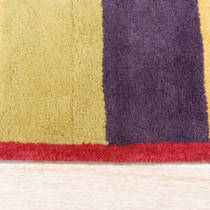High-pile rug featuring red, purple, chartreuse, and gold color blocks resting on light hardwood flooring.