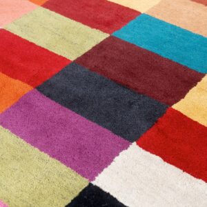 Vibrant multicolored rug featuring a close-up geometric pattern of varied bright rectangular blocks.