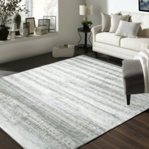 Abstract silver and white striped rug lies on dark hardwood flooring in a modern living space.