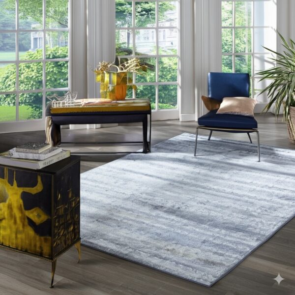 A low-pile blue and gray streaked rug grounds a bright room with dark wood floors and large windows.