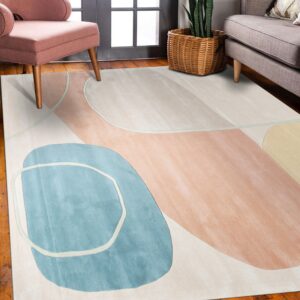 Abstract cream rug featuring blue and blush curvilinear shapes sits under a pink chair and gray sofa.