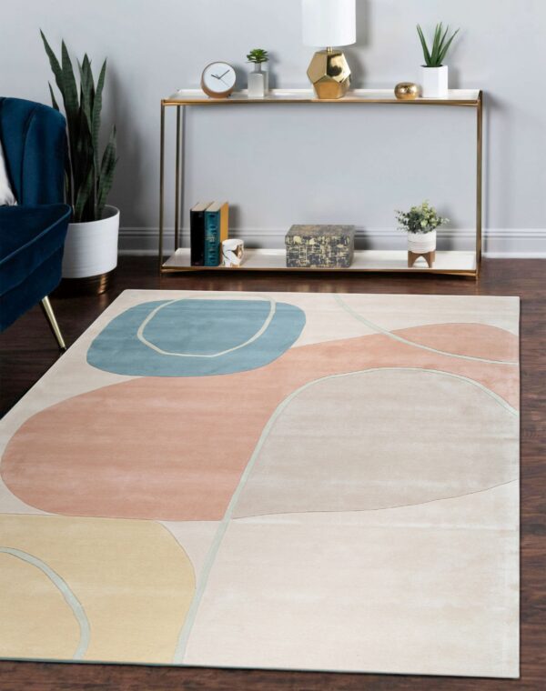 Muted abstract rug featuring large peach, blue, and yellow shapes in a contemporary living area.
