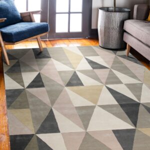 Geometric triangle rug in shades of gray and beige anchors a room with wood floors and bright doors.