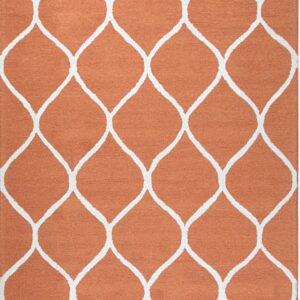 Full view of a textured orange rug with a repetitive white geometric ogee trellis design.