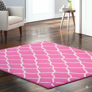 Bright pink rug with a white geometric lattice pattern rests on shiny dark hardwood flooring.