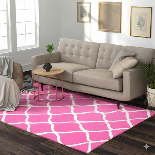 A bright pink and white geometric rug lies beneath a beige sofa on dark wood flooring.