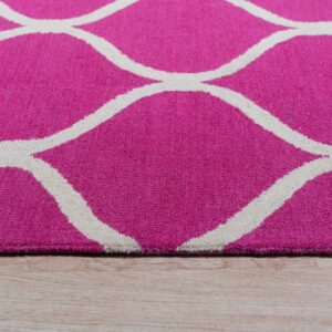 Close-up of a pink textured rug with a thick white trellis pattern on light wood flooring.