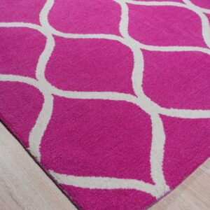 A vibrant pink rug with a cream lattice pattern rests on light blonde wood plank flooring.