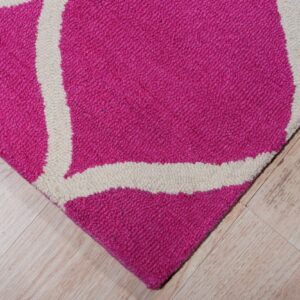 A magenta and cream geometric rug with visible loop texture rests on light wood plank flooring.