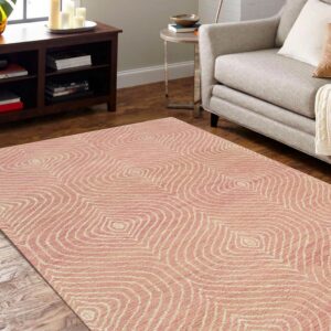 A low-pile pink and cream rug with a wavy concentric pattern is placed on wood floors near furniture.