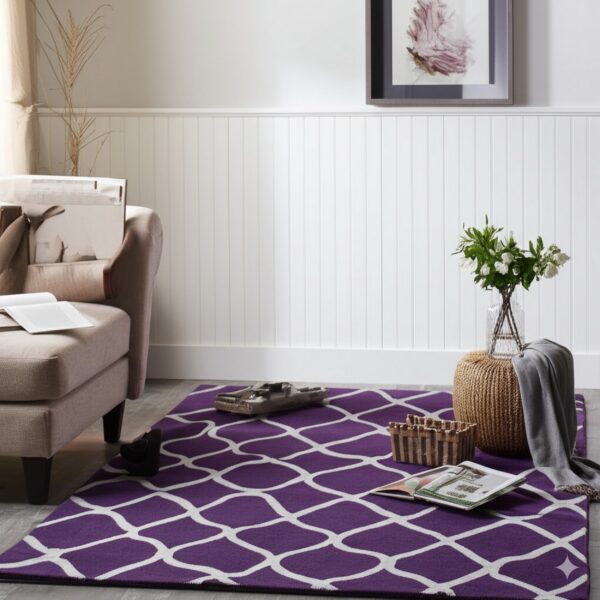 A purple and white geometric rug sits on gray flooring beside a beige armchair and white wainscoting.