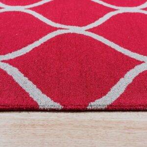 Close-up of a red, medium-pile rug with a gray geometric pattern resting on light wood flooring.