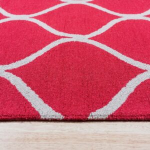 Bright pink medium pile rug featuring a repeating gray quatrefoil pattern on light wood flooring.