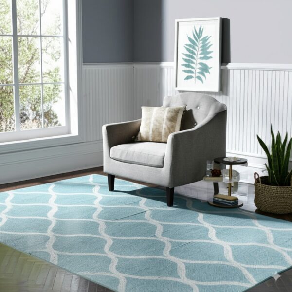 Light blue rug with a white ogee pattern brightens a gray living room with wainscoting and an armchair.