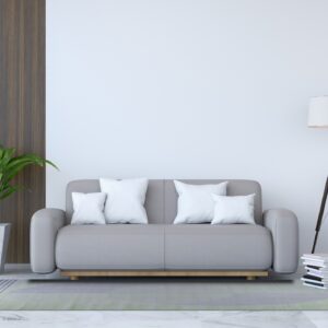 Modern room with a striped green and lavender rug under a gray couch and white pillows on marble flooring.