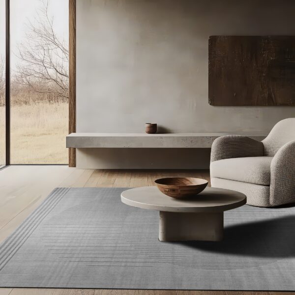Gray rug with subtle horizontal stripe pattern anchors a neutral living space with modern furniture.