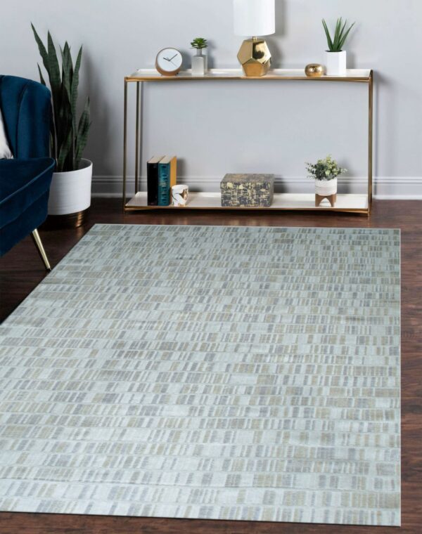 Low-pile gray and tan rug with a linear dash pattern sits on wood floors in front of a console table.