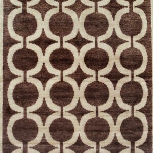 Geometric rug featuring brown linked circles and star shapes against a light cream field.