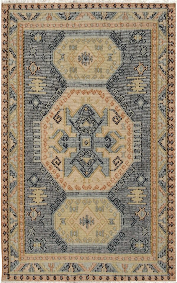 Geometric rug featuring navy blue, cream, gold, and peach tribal patterns and tassels.