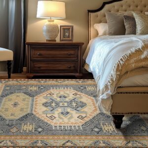 A low-pile rug with geometric blue, cream, and rust patterns rests beside a wooden nightstand and upholstered bed.