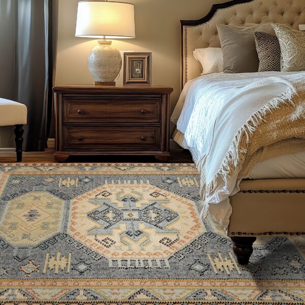 A low-pile rug with geometric blue, cream, and rust patterns rests beside a wooden nightstand and upholstered bed.