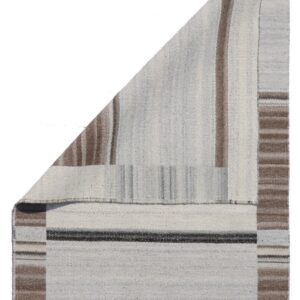 Folded flatwoven rug displaying light gray, brown, and dark gray vertical and horizontal stripes.