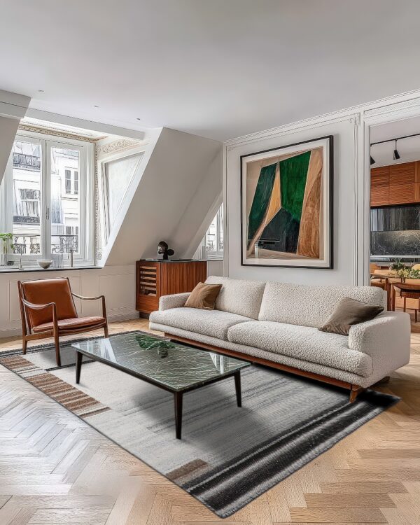 White and dark gray striped rug centered below a marble coffee table on herringbone wood floors.