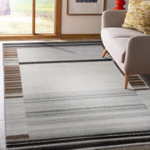 A gray and brown striped flatweave rug sits under a beige armchair near a large window.