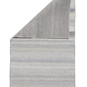Flatwoven rug with subtle gray and off-white horizontal stripes, folded to show the solid heather gray backing.
