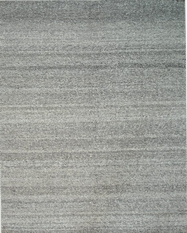 Detailed view of a low-pile rug showing a black and white woven chevron pattern.