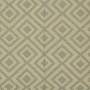 Flatweave rug displaying a repeating geometric diamond pattern in pale beige and dusty blue-gray.