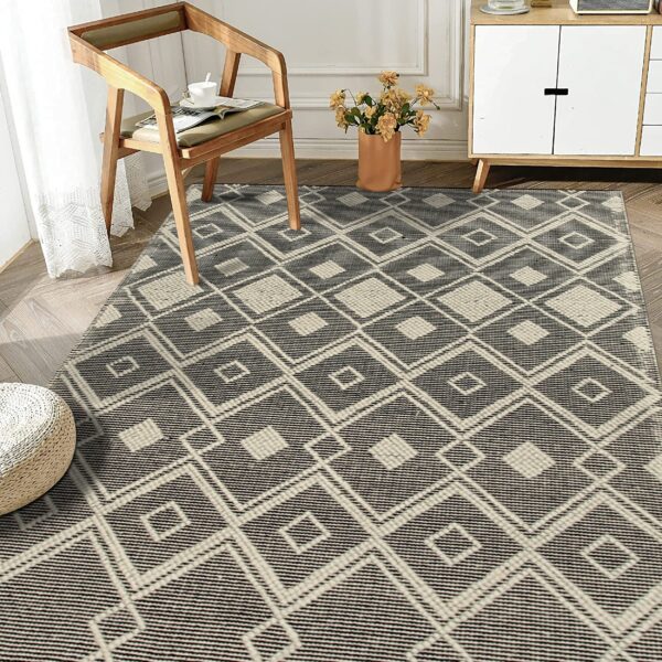 Textured black and cream geometric rug with diamonds anchors a sitting area with a wooden chair and cabinet.