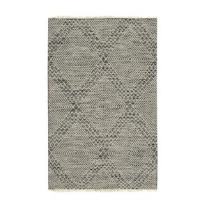 Black and white geometric patterned rug with textured diamonds and short tassels on the ends.