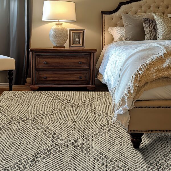 Cream and dark brown geometric rug on wood flooring next to a nightstand and tufted bed.