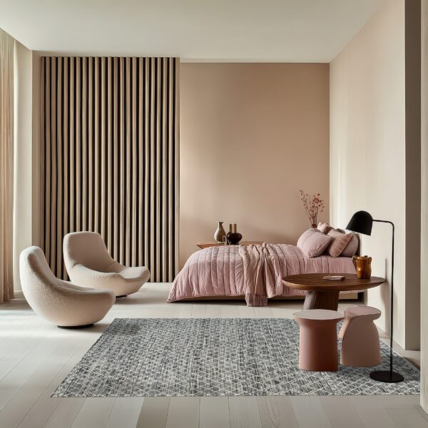Geometric gray and white rug in a modern bedroom with pale pink walls, a slatted panel, and curved seating.