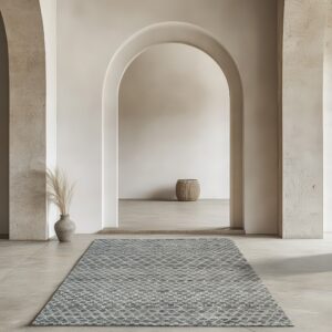 Geometric gray and cream runner rug on stone flooring in a minimalist room featuring arched columns.