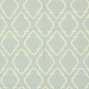 Light blue flatweave rug featuring a repeating cream ogee geometric pattern.