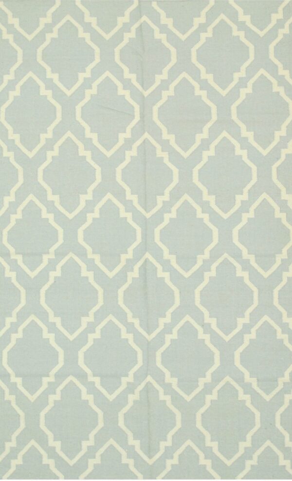 Light blue flatweave rug featuring a repeating cream ogee geometric pattern.