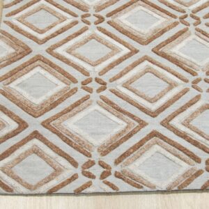 Brown, beige, and white raised geometric diamonds on a light gray rug next to wood flooring.