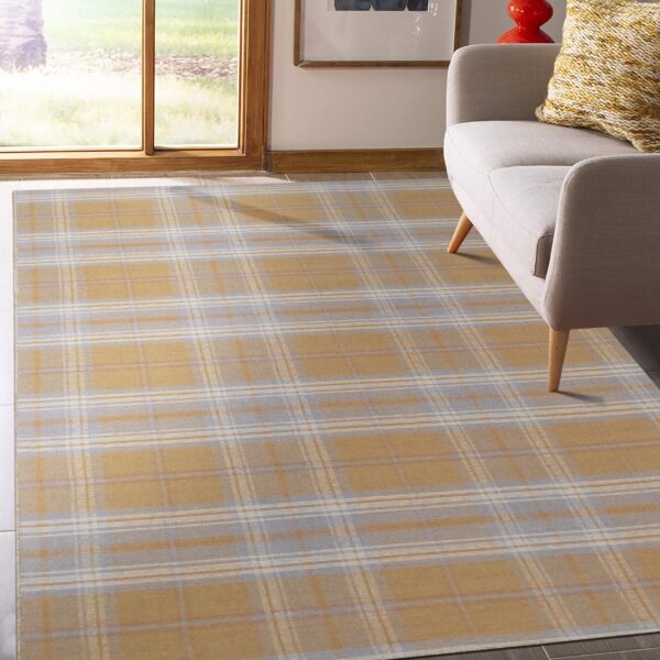 Gold and gray plaid area rug sits beneath a light-colored sofa near a large window.