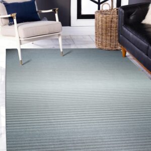 A gradient striped rug transitions from dark teal to light gray, resting beneath furniture on white marble tile flooring.