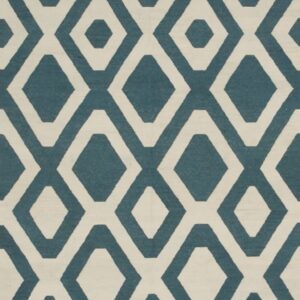 Low-pile rug showing a geometric pattern of interlocking diamonds in teal blue and cream.