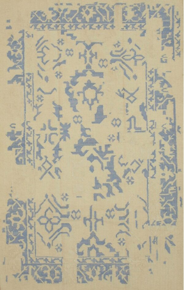 Geometric light blue motifs and fragmented borders are scattered across a cream flatweave rug.