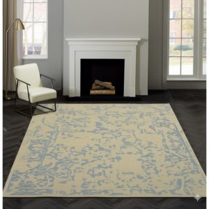Beige and blue abstract rug sits on dark herringbone floor near a white fireplace and cream chair.