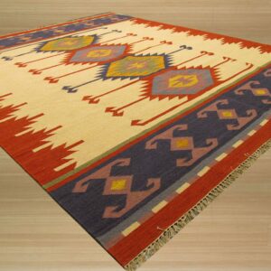 Flat-weave rug featuring a cream central field, multicolored geometric motifs, and a dark indigo and rust border.